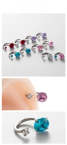 Macro detail of horseshoe ear studs with sparkling cubic zirconia in multiple colors