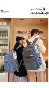 Close-up of minimalist large-capacity backpacks in blue and grey with side mesh pockets