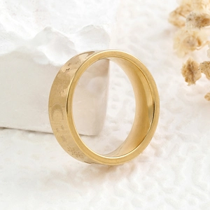 Golden stainless steel sun moon and star ring on white stone background