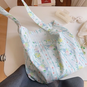 Close-up of lightweight floral cotton tote bag with fresh blue stripes and patterns