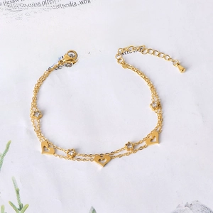 Double-layered gold titanium steel bracelet with hollow hearts and zircon star charms