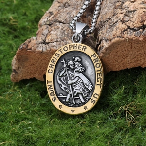 Macro shot of two-tone Saint Christopher pendant necklace on natural wood background