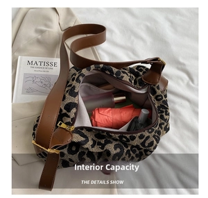 Detail showing spacious interior of leopard print tote bag with umbrella and skincare items
