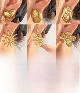 Detail of vintage gold-plated stainless steel earrings with embossed textures on model