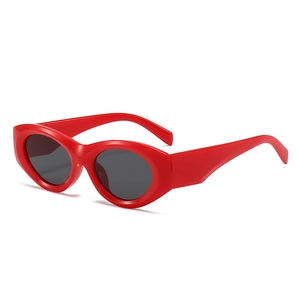 Retro red oval sunglasses for women featuring dark lenses and a minimalist chic frame