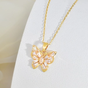 Close-up of golden butterfly pendant with marquise and rectangular cubic zirconia stones