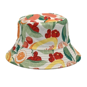 Detailed view of vibrant orange and cherry fruit prints on a cotton bucket hat