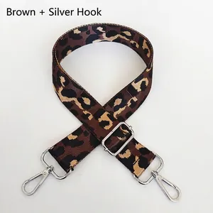 Detail of coffee leopard print nylon strap with adjustable silver metal hooks