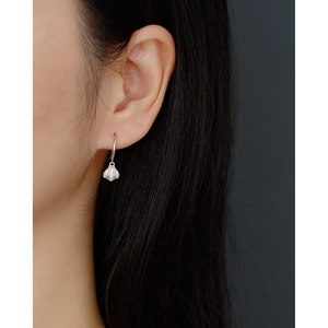 Close-up of a S925 sterling silver shell earring with crystals on a female model