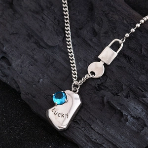 Vintage silver necklace with a blue round gemstone pendant and Lucky engraving detail