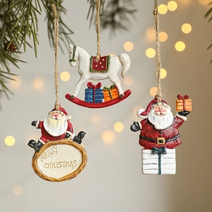 Festive Santa and rocking horse ornaments hanging on pine branches with bokeh lights