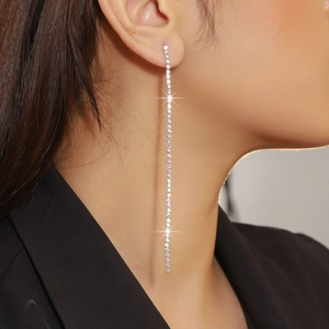 Detailed view of elegant silver long tennis style tassel earrings with sparkling crystals