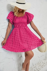 Détail d'une mini robe rose fuchsia à manches bouffantes avec texture à carreaux et taille