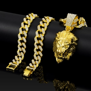 Classic gold lion head pendant necklace with iced out Cuban chain on black background