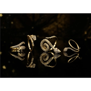 Vintage 18K gold plated copper snake rings with AAA zircon inlays on black mirror
