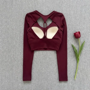 Flat lay of burgundy slim-fit yoga top with cutout back and removable chest pads