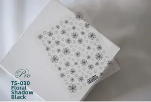 Detail of TS-030 5D nail sticker with black floral patterns on a minimalist white stand