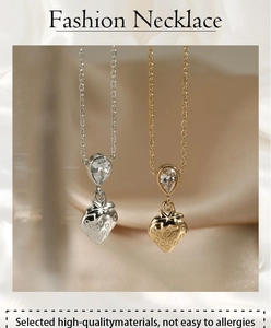 Detailed close-up of strawberry pendant necklace with sparkling droplet-shaped zircons