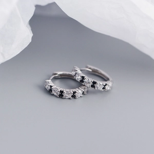 Macro shot of S925 silver hoop earrings with black and white zircon stone setting