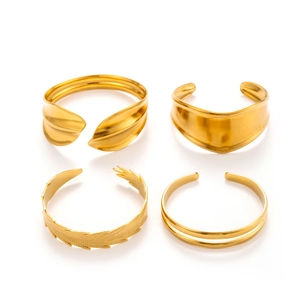 Set of four gold stainless steel adjustable open bangles with unique textured metal patterns