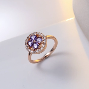 Elegant rose gold ring with a purple clover-shaped gemstone and cubic zirconia accents