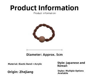 Macro shot of 5cm diameter brown elastic hair tie with a matte acrylic bead detail