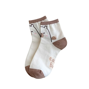 White and brown cotton ankle socks featuring a cute cartoon bear and ca b text design