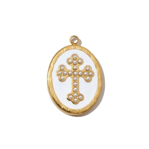 Macro view of gold-plated cross pendant featuring white pearl inlay and enamel oval frame