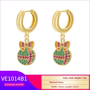 Detailed view of gold brass Christmas ball earrings with bow and cubic zirconia