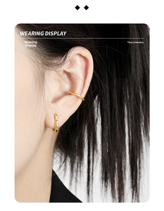 Detail showing irregular hammered texture on gold U-shaped earring and ear cuff on model