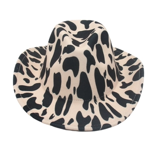 Classic wide brim cowboy hat featuring a black and white cow print felt texture