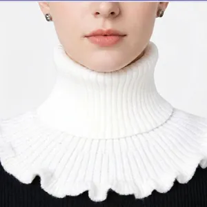 Detail of white high-neck knitted fake collar featuring elegant ruffled edges and ribbed texture
