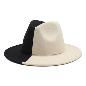 Close-up of the two-tone black and beige felt fedora hat with a flat brim detail