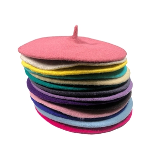 Stack of colorful knitted beret hats for women in minimalist Japanese painter style
