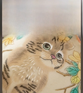 Detail of hand-painted ceramic cat tea cup with delicate textures and floral patterns