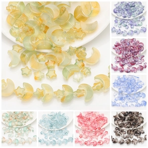 Detailed view of colorful iridescent glass moon and star beads for DIY jewelry making