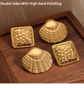 Detail of square hammered texture and shell-shaped earrings in polished gold steel