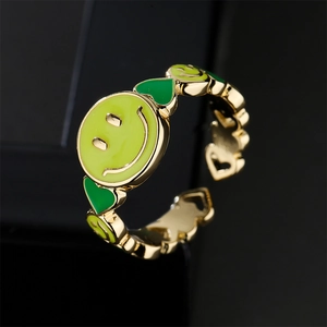 Adjustable gold plated copper ring featuring green enamel smiley face and heart patterns