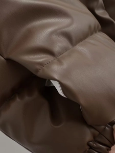 Detail of dark brown faux leather quilted texture on minimalist casual vest jacket