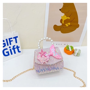Detail of sequin mermaid tail and starfish ornaments on girl's purple tweed pearl handbag