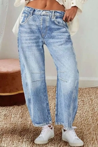 Detailed macro view of high-waisted wide-leg denim jeans with stone washed texture