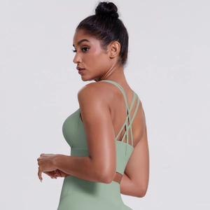 Detail of light green sports bra featuring multi-cross back straps and elastic fabric