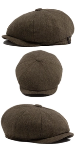 Detailed view of dark brown tweed newsboy cap showing octagonal pattern and fabric texture