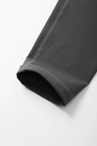 Detail of flatlock stitching on a charcoal grey high-elastic yoga jacket sleeve