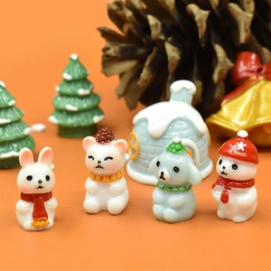 Close-up of miniature resin Christmas figurines featuring cute rabbit, bear, dog, and snowman