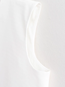 Macro detail of high-quality white vest shoulder seam and premium twill fabric texture