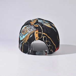 Detailed back view of vintage baseball cap featuring gold baroque prints and metal buckle