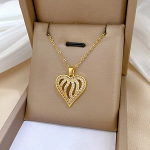 Close-up of gold heart pendant necklace with rhinestones in a luxury jewelry box