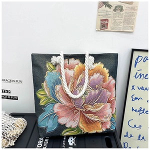 Detail of floral peony embroidery on canvas tote bag with thick cotton rope handles