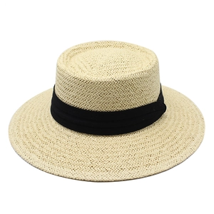 Classic straw boater hat with black ribbon for sun protection and beach vacation